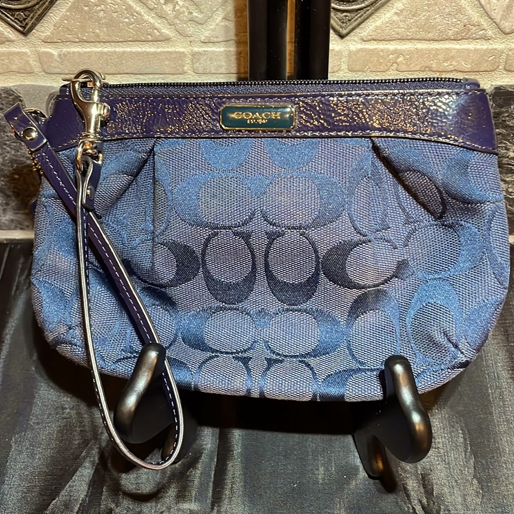 EUC Coach wristlet in navy monogram canvas Interior in gray with one card slot